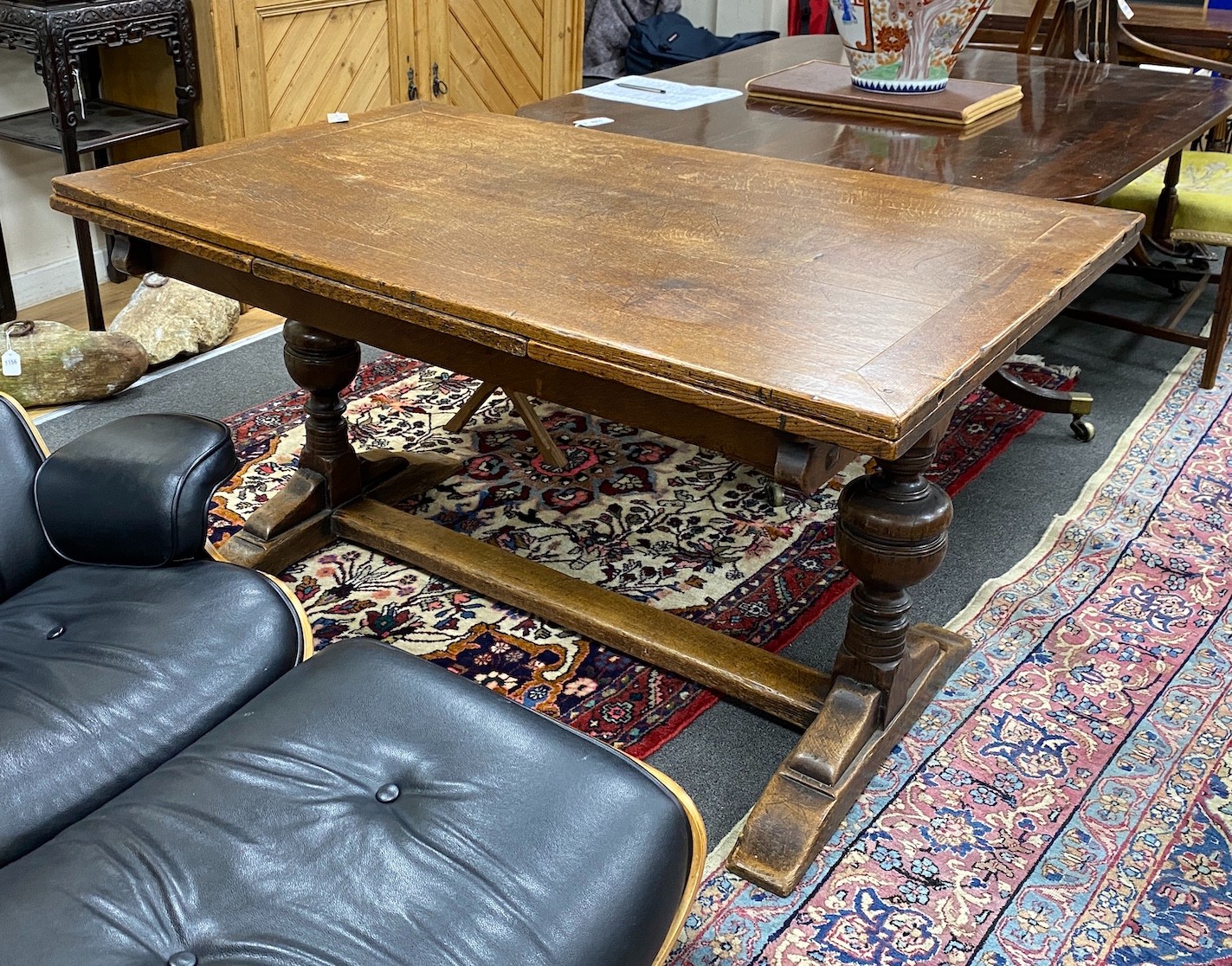 A 1930's oak draw leaf dining table, length 136cm, width 83cm, height 74cm
